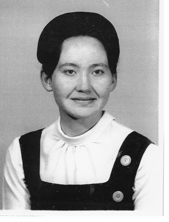 Darlene Marie Dewegeli, photographed in black and white in a white blouse and dark pinafore.