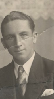 Karl Franz Dewegeli Jr., a young man in a suit and striped tie, photographed in black and white.